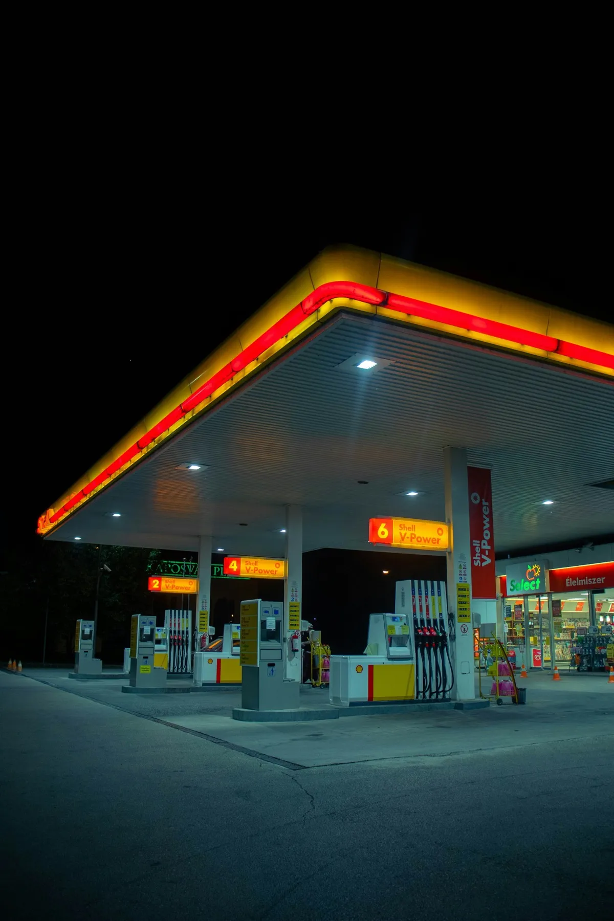 A petrol station lit up at night.